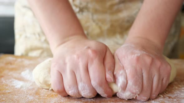 Close Up of Woman Hands Crumple Dough