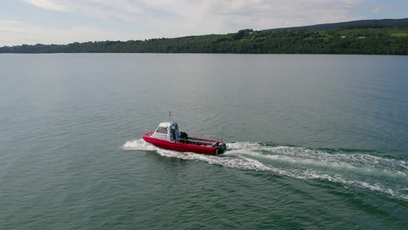 A Small Passenger Ferry at Sea Motoring Alongside an Island