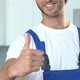 Handsome workman smiling and showing thumbs-up gesture - VideoHive Item for Sale