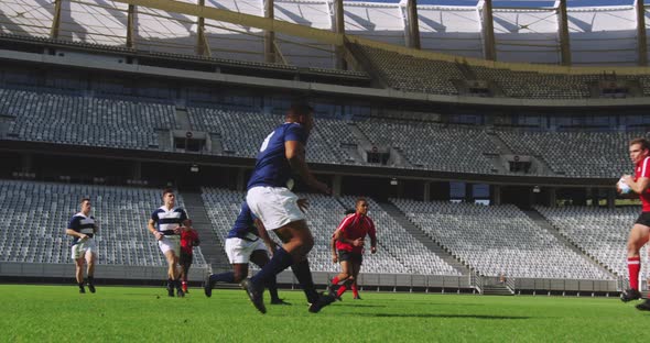 Rugby Players Playing Rugby Match in Stadium