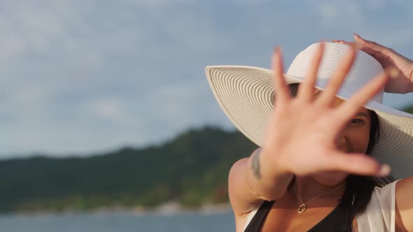 Woman In Sun Hat Smiling In Bright Sunlight