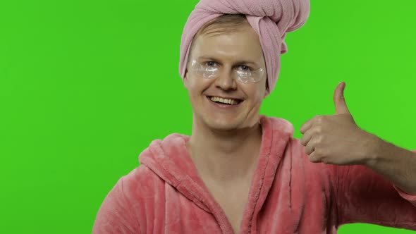 Transsexual Man in Bathrobe and Eye Patches Giving Thumbs Up. Chroma Key