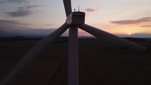 Silhouette of Windmill Turbine in Field at Sunset Sky