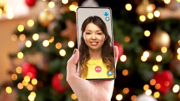 Woman with Smartphone Has Video Call on Christmas