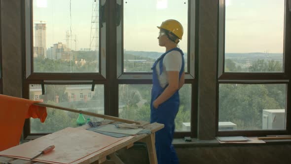 Young Worker on Construction Site Looking at City