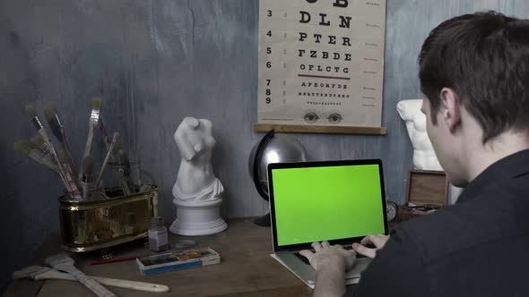 Man Typing On The Computer With Green Screen