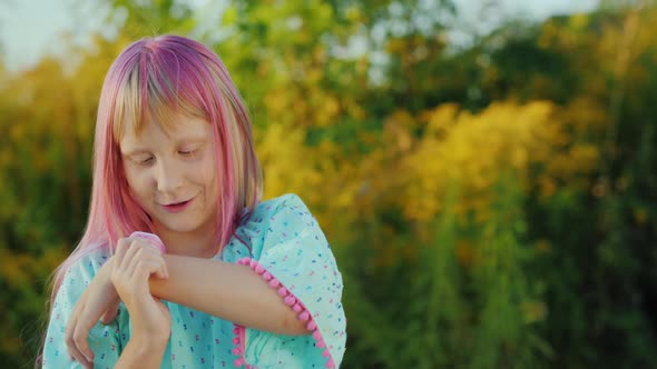 Cheerful Girl Talking to Smart Watch on a Clear Summer Day