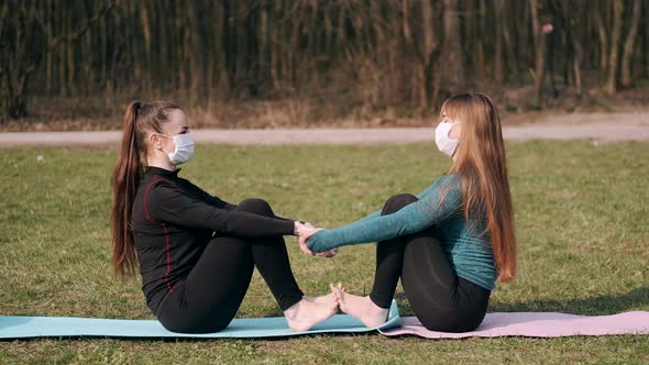 Sport Women Are Doing Morning Yoga Exercise Outside on Mats