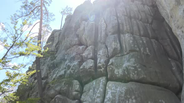 Young Child Boy Climbing Steep Wall of Rocky Mountain