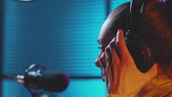 Young radio host talking into the microphone