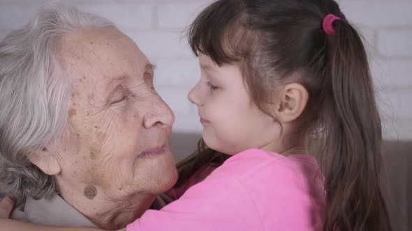 Happy child hugging grandmother. 