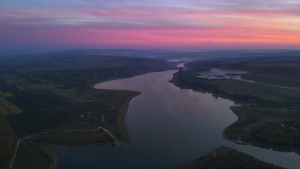 Aerial drone view of the Duruitoarea natural reservation at sunset in Moldova. River and village, hi