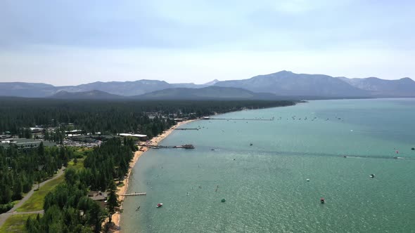 Swimming Tourists And Floating Boats At Lake Tahoe In California, United States. Aerial Wide Shot