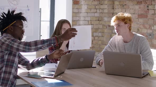 Three Confused Nervous Coworkers Discussing Startup in Office. Portrait of Multiethnic Team Planning