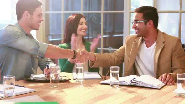 Casual Businessman Shaking Hand During Meeting