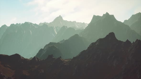 Rocks Covered with Grass Under a Cloudy Sky