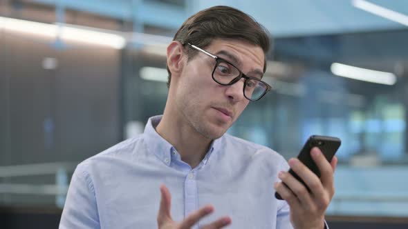 Portrait of Aggressive Young Man Angry on Smartphone