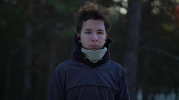 Portrait of Teenager in a Winter Pine Forest.