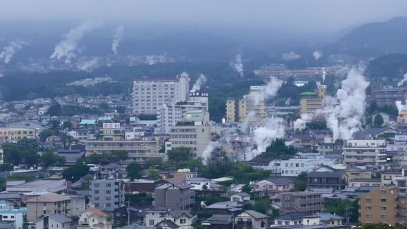 Beppu city, Japan cityscape with hot spring bath houses and rising steam 