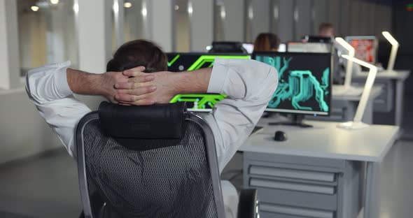 Male Young Engineer Relaxing at Workplace in Laboratory