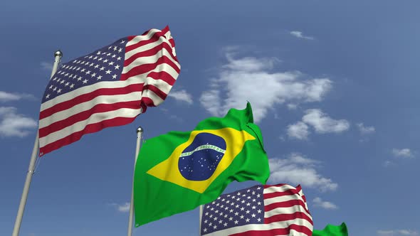 Waving Flags of Brazil and the USA on Sky Background