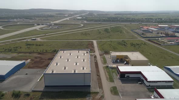 Aerial view of Industrial buildings next to the highway and transport interchange 01