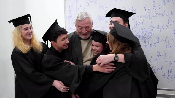 Graduates Hug with Their Professor in University