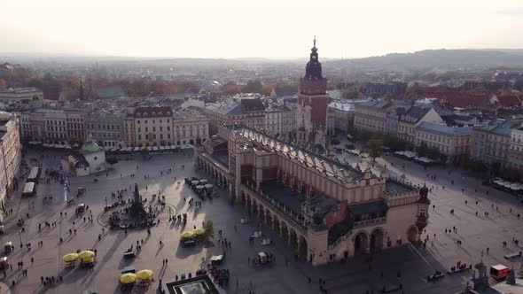 Main Market Square With Cloth Hall (Sukiennice) And Town Hall Tower In Krakow City, Poland. - aerial