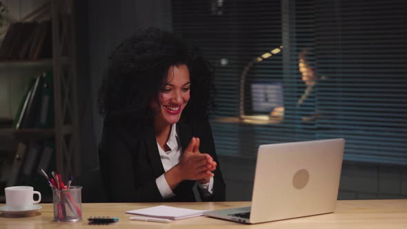 Portrait African American Woman Texting with Client Using Laptop and Rejoices at Good Deal