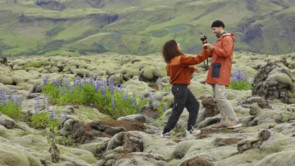 Man Photographing Hiking Partner In Mossy Landscape