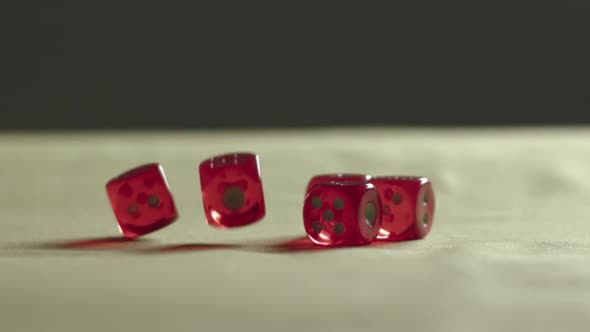 Red Dice Falling On The Table In Casino.