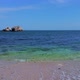 Sunny Beach with Blue Sea Water, Blue Sky and Rocks on the Horizon in a Summer Day. Wide shot - VideoHive Item for Sale