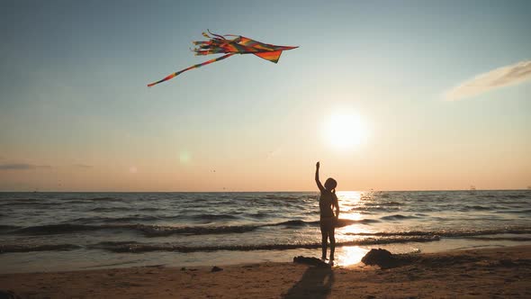 Happy Little Girl Playing with the Kite on a Sunny Day. Young Cute Child Playing with a Colorful