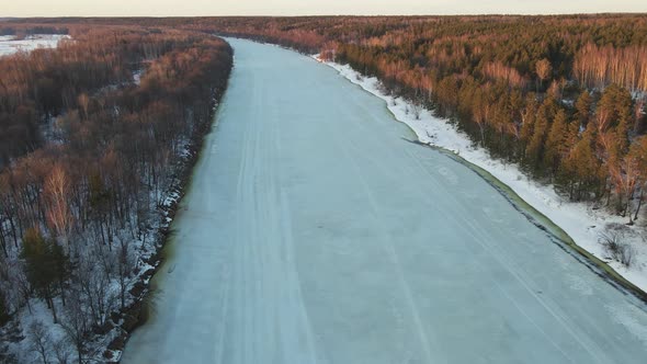 Unusual Winter Landscape with a Frozen River at Sunset Aerial View