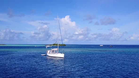 Drone aerial seascape of marine resort beach break by lagoon with sand background