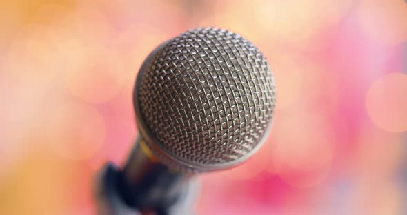 Microphone on Stage Against a Blurry Light ,Blurry Background.