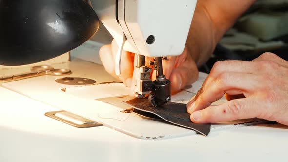 Shoemaker Using Vintage Sewing Machine at His Workshop 1080p