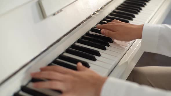 Closeup Top View of Unrecognizable Young Woman Musician Performer Playing on Classical Piano at Home