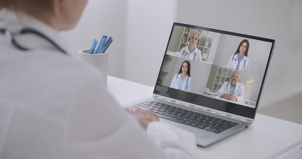 Close Up of Young Female Talk on Video Call Consult with Diverse Doctors Colleagues, Woman Patient