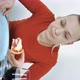 Vertical Video Woman at Home at the Table Eating Pizza with His Hands - VideoHive Item for Sale