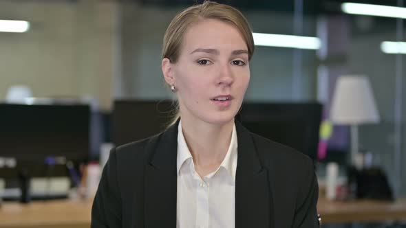 Portrait of Young Businesswoman Saying No By Shaking Head