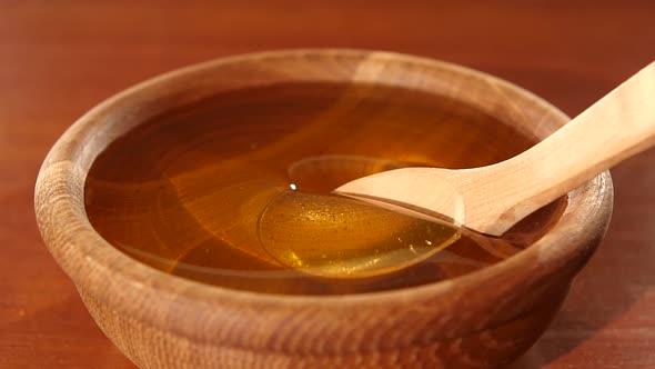 Taking Honey By Using Spoon in Wooden Bowl, Slow Motion