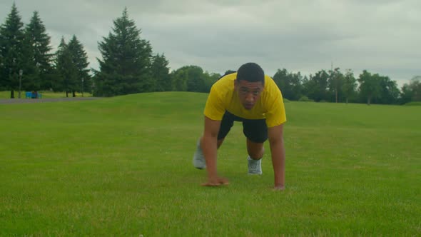 Sporty Fit African American Man Practicing Lateral Bear Crawl Exercise Outdoors