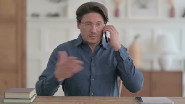 Young Man Talking on Phone in Office