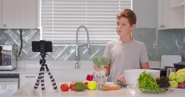 Boy Videoblogger Cooking Meal and Recording Video for Blog