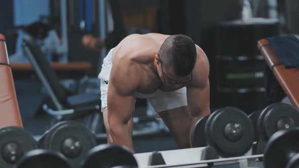 Arab Male Athlete Improves His Shoulders with Dumbbell Breeding