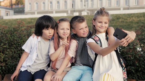 Little boys and girls making self-portrait photographs.