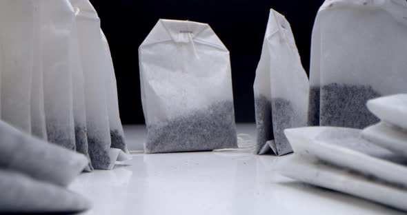 Super Closeup Set of Tea Bags on a White Table on a Black Background