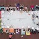 Aerial View of a Group of Women and Children Engaged in Creativity on a Wooden Terrace in the Open - VideoHive Item for Sale