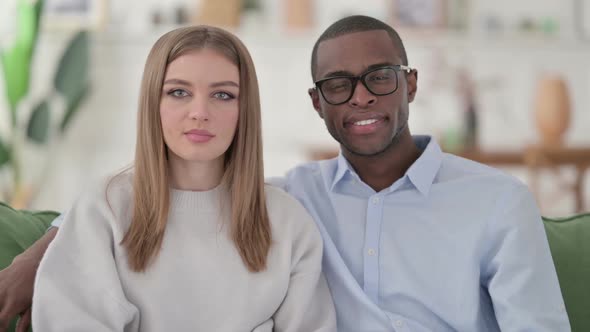 Positive Mixed Race Couple Showing Thumbs Up Home